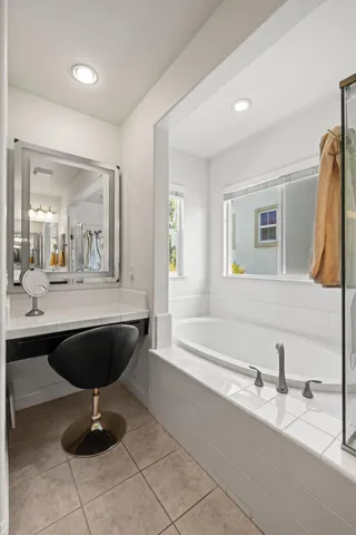 a bathroom with a sink a bathtub and a mirror