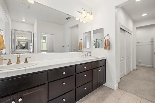 a bathroom with a double vanity sink double and mirror