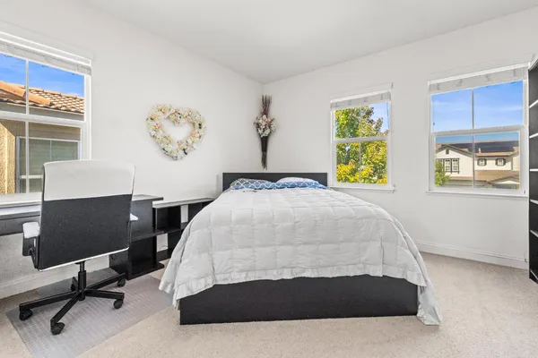 a bedroom with a bed and chair