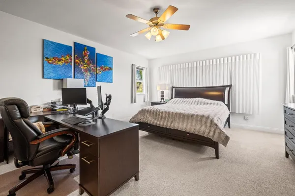 a bedroom with a workspace