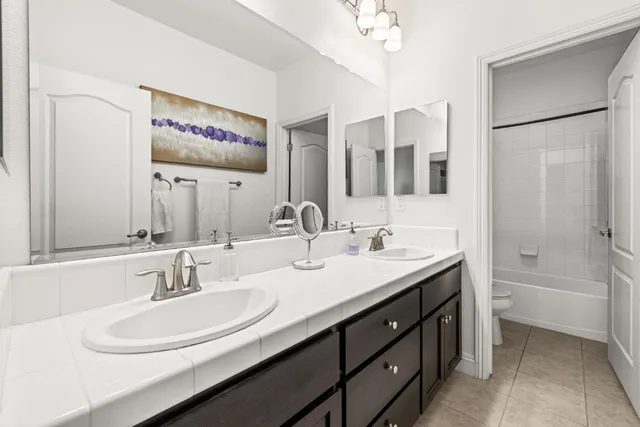 a bathroom with a double vanity sink and a mirror