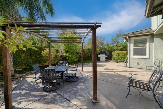 a view of a patio with table and chairs and potted plants