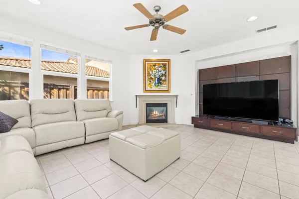 a living room with furniture a flat screen tv and a fireplace