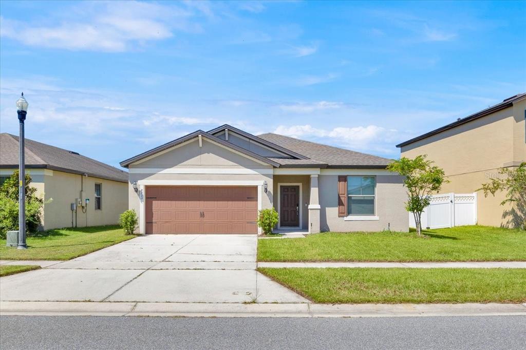 a front view of a house with a yard and garage