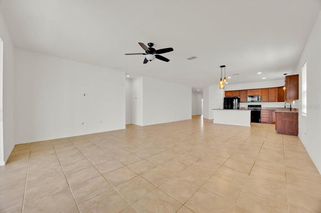 8755 Rindge Road Polk City, FL 33868 - Photo 11 of 25 a view of a kitchen with furniture and a ceiling fan