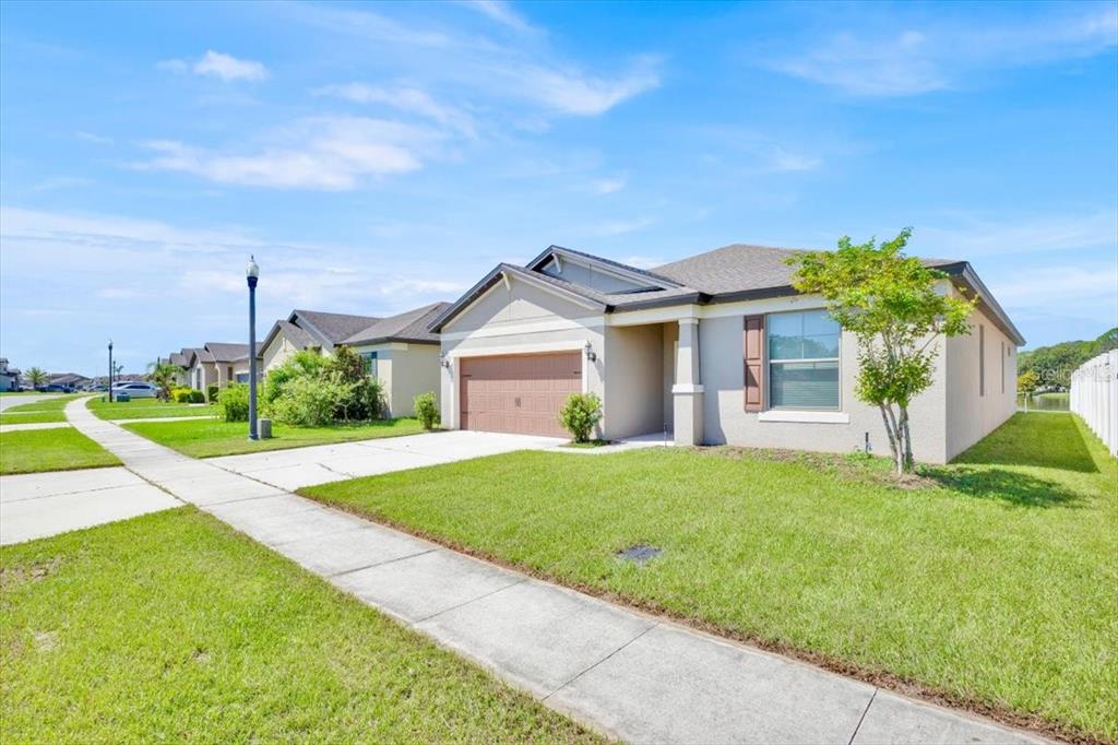 8755 Rindge Road Polk City, FL 33868 - Photo 2 of 25 a view of a house with a big yard plants and large trees