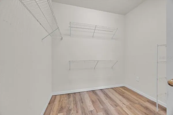 an empty room with fan and windows