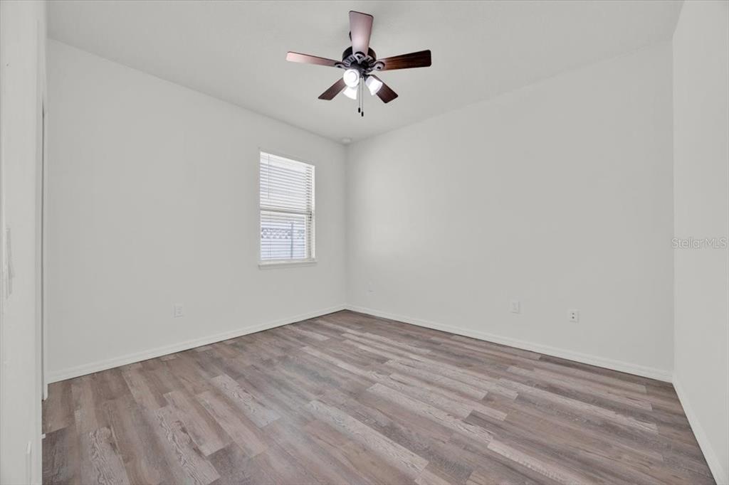 8755 Rindge Road Polk City, FL 33868 - Photo 24 of 25 an empty room with fan and windows