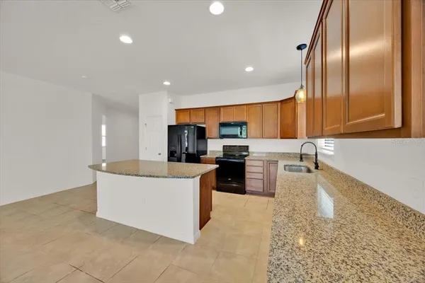 a view of a kitchen with furniture and a ceiling fan