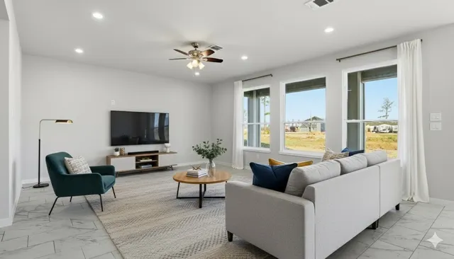a living room with furniture and a flat screen tv