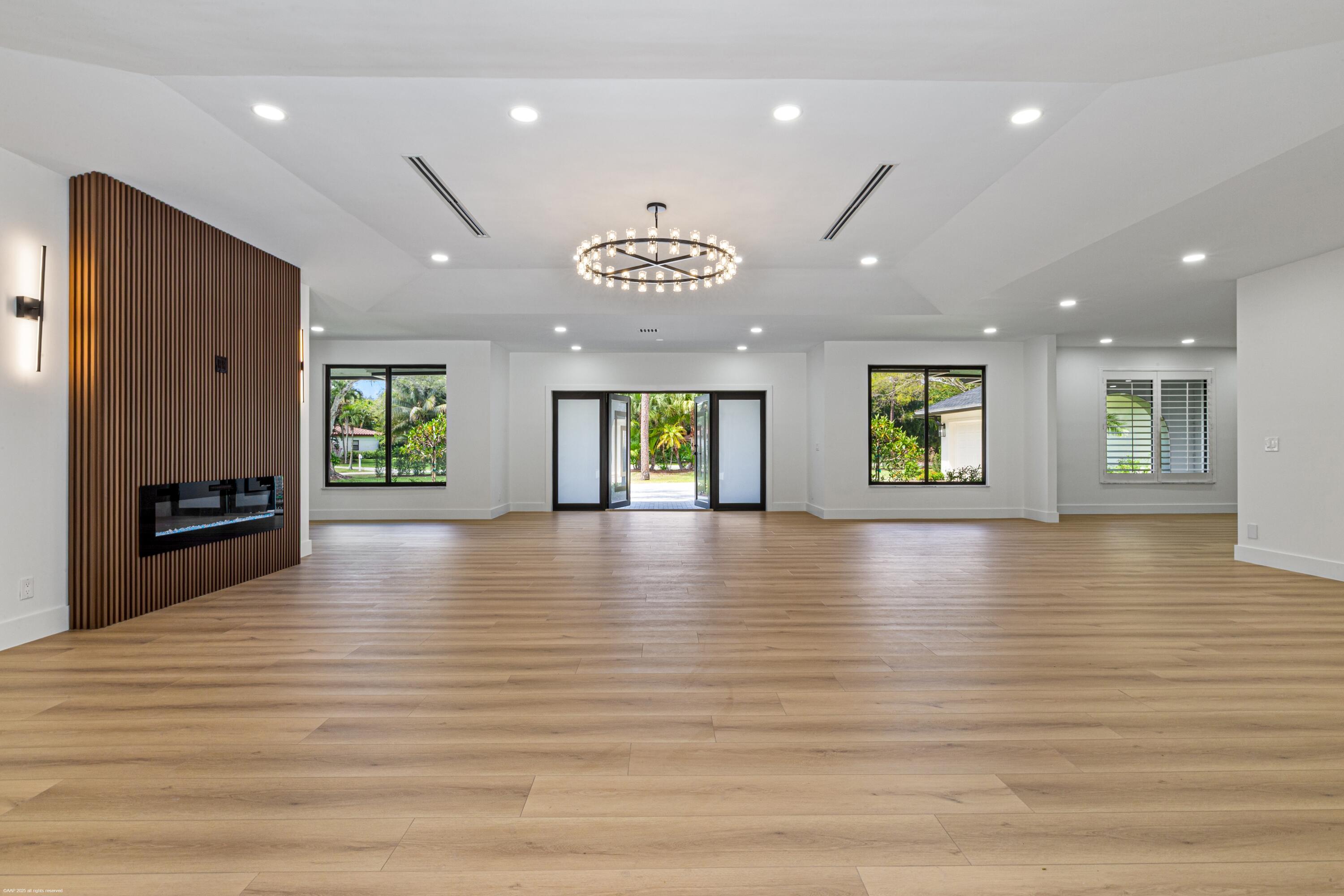 13453 Doubletree Trail Wellington, FL 33414 - Photo 12 of 65 an empty room with wooden floor and windows