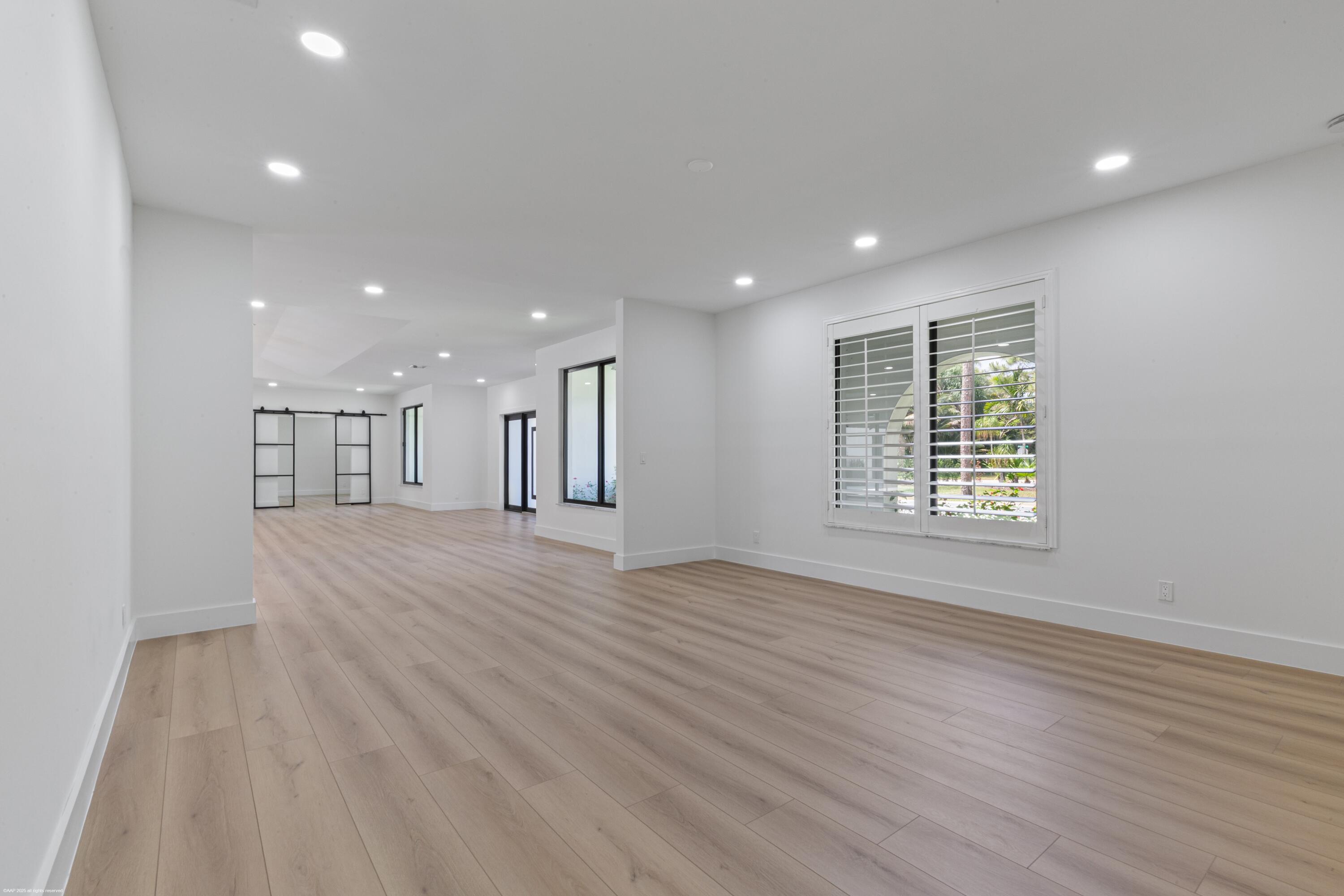 13453 Doubletree Trail Wellington, FL 33414 - Photo 26 of 65 an empty room with wooden floor and windows