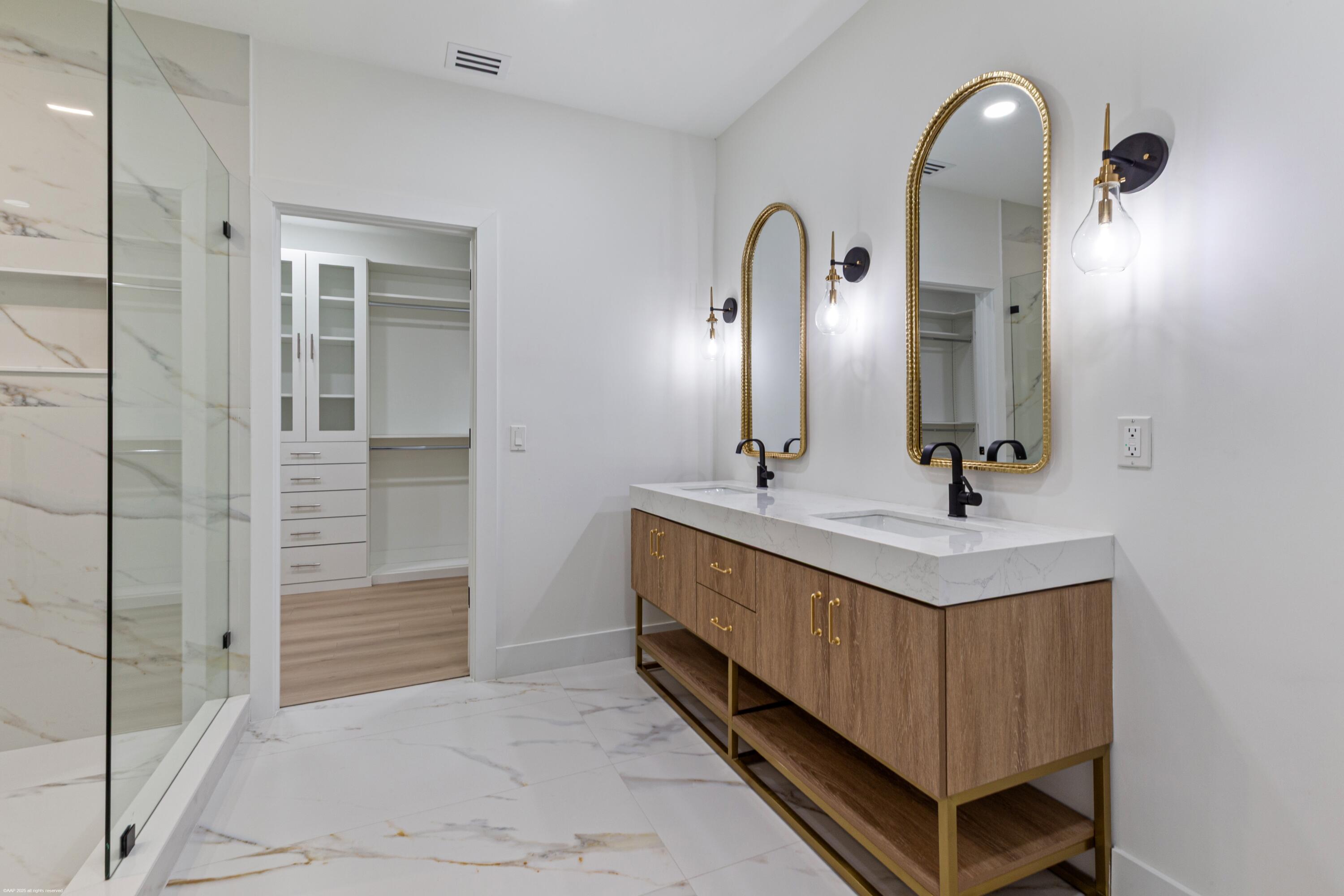 13453 Doubletree Trail Wellington, FL 33414 - Photo 34 of 65 a bathroom with a double vanity sink and a mirror