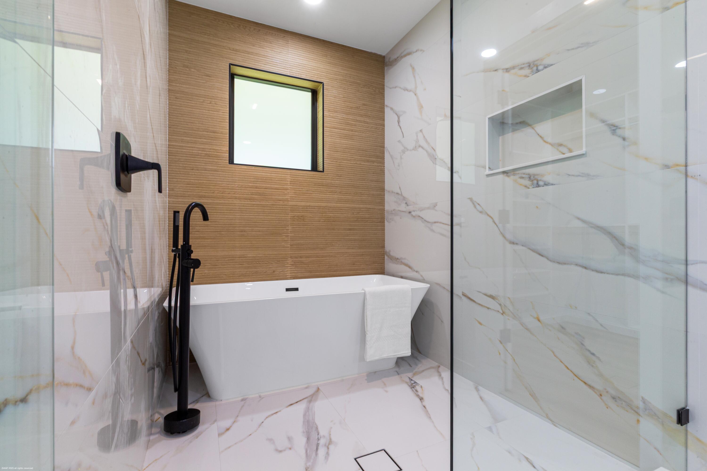 13453 Doubletree Trail Wellington, FL 33414 - Photo 35 of 65 a bathroom with a bathtub and a shower