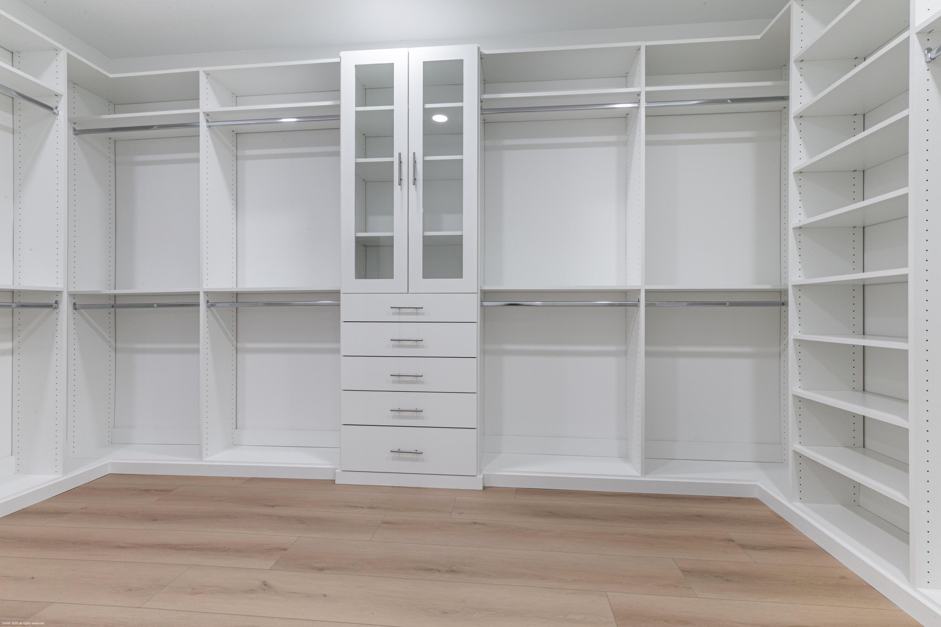 13453 Doubletree Trail Wellington, FL 33414 - Photo 36 of 65 a view of walk in closet with empty racks