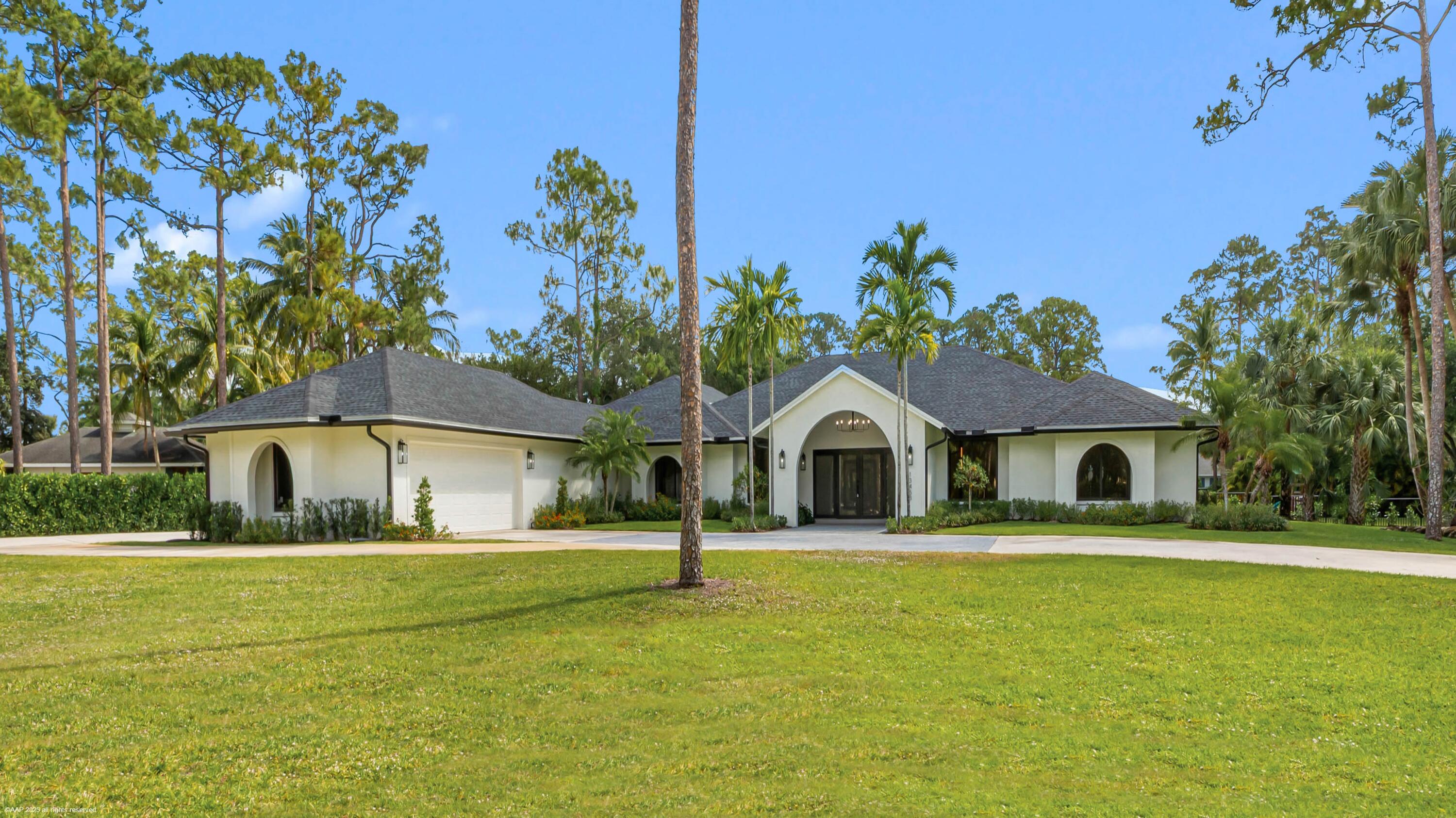 13453 Doubletree Trail Wellington, FL 33414 - Photo 4 of 65 a front view of a house with a yard
