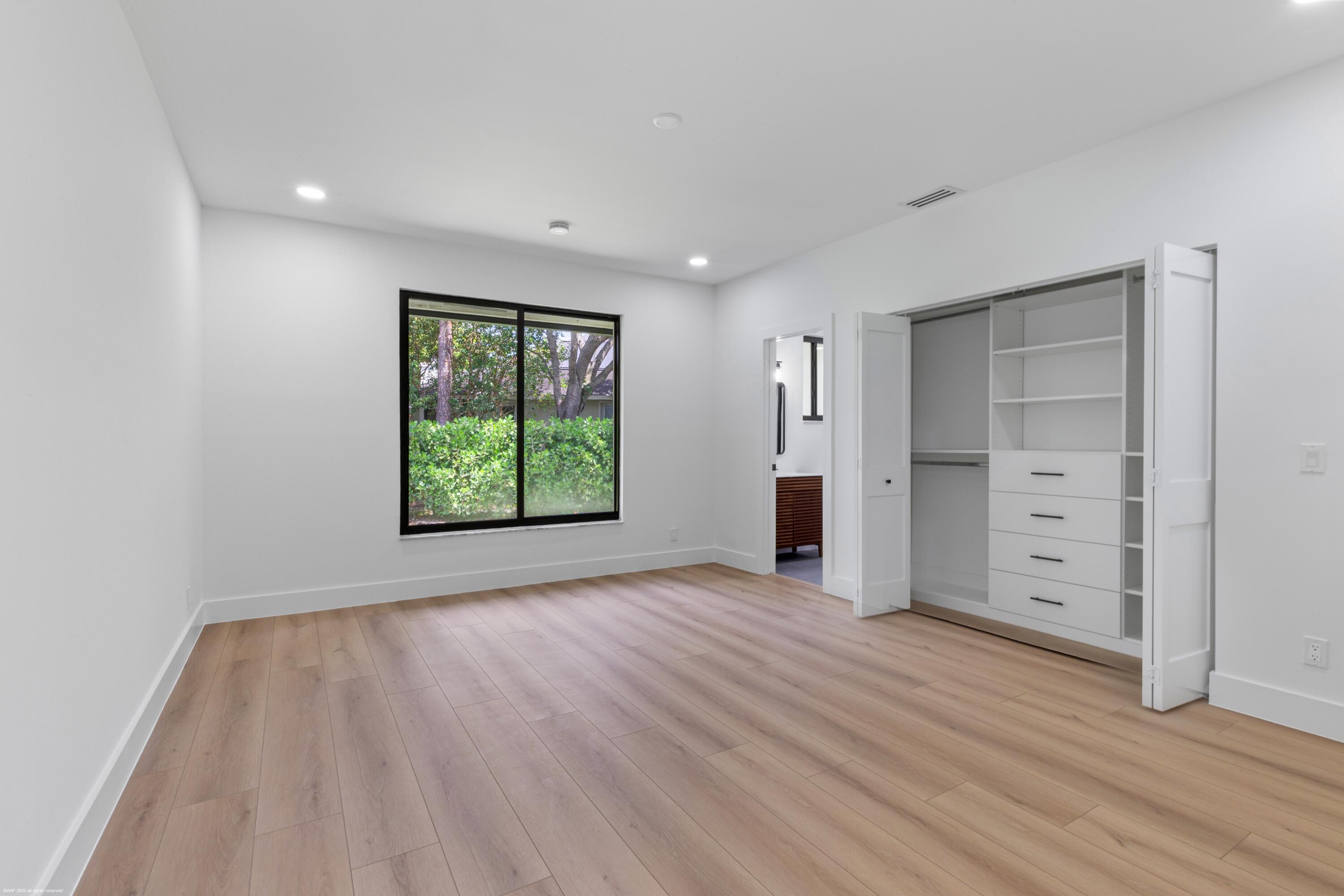 13453 Doubletree Trail Wellington, FL 33414 - Photo 43 of 65 wooden floor in an empty room with window and wooden floor