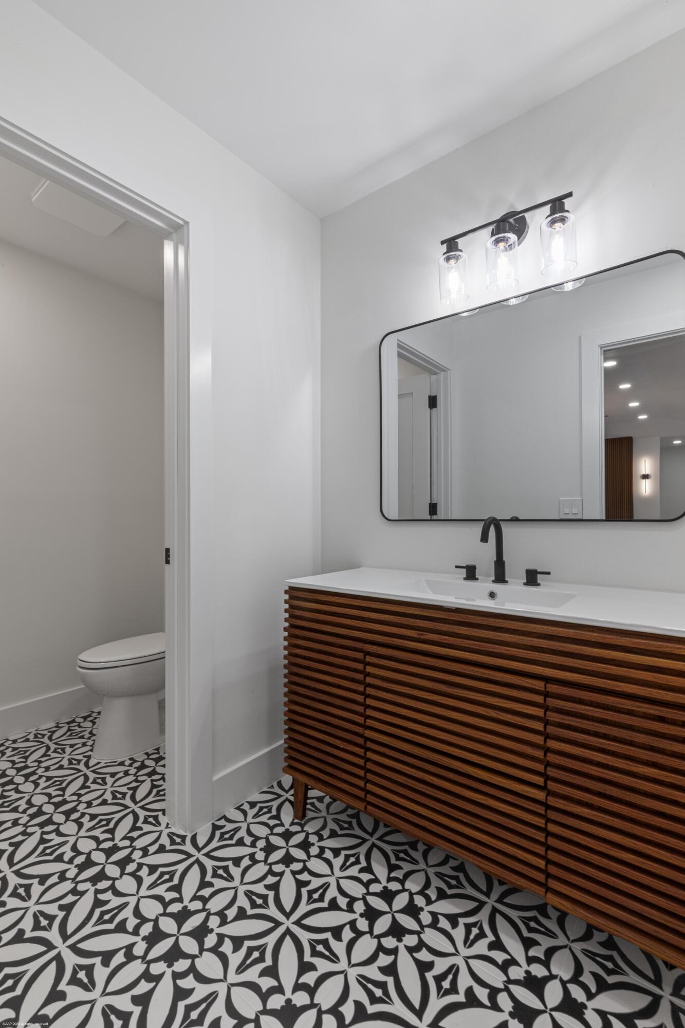 13453 Doubletree Trail Wellington, FL 33414 - Photo 49 of 65 a bathroom with a sink and a mirror