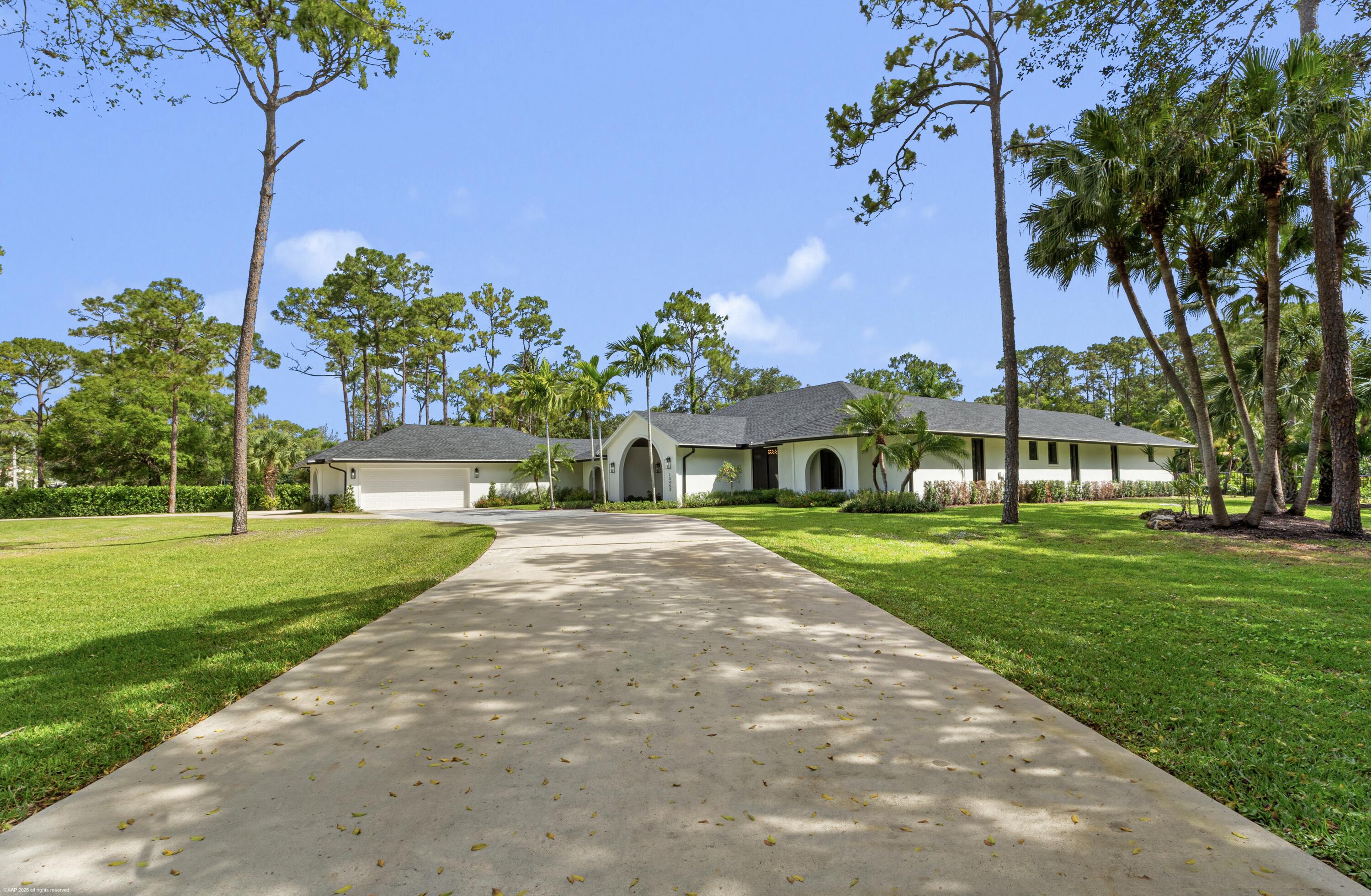 13453 Doubletree Trail Wellington, FL 33414 - Photo 6 of 65 a front view of a house with garden