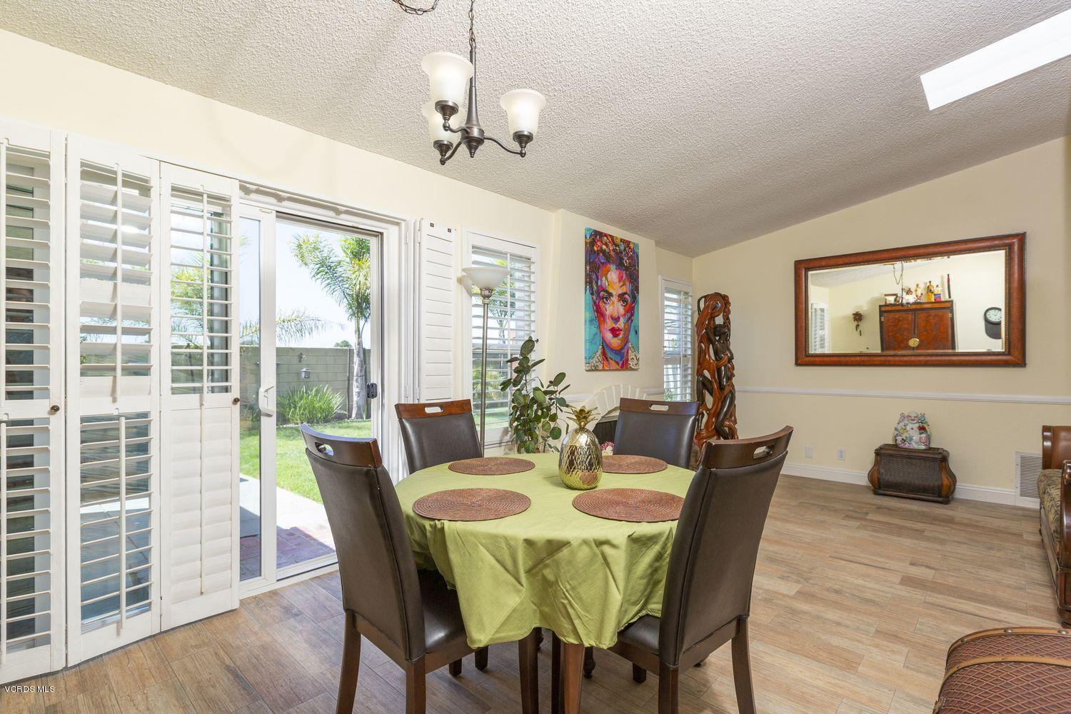 1411 Kelp Street Oxnard, CA 93035 - Photo 11 of 24 a view of a dining room with furniture window and wooden floor