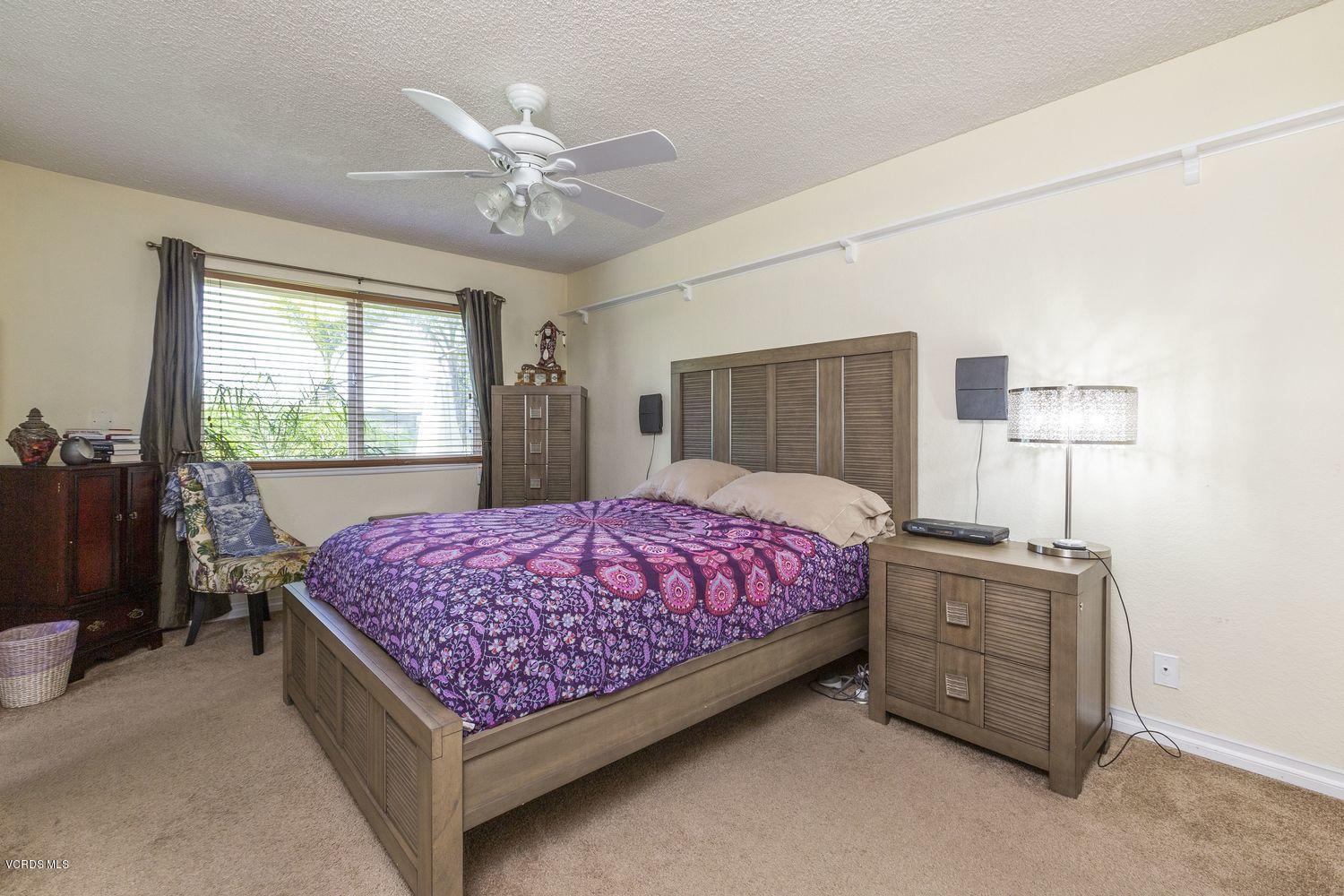 1411 Kelp Street Oxnard, CA 93035 - Photo 13 of 24 a bedroom with a bed and a chandelier