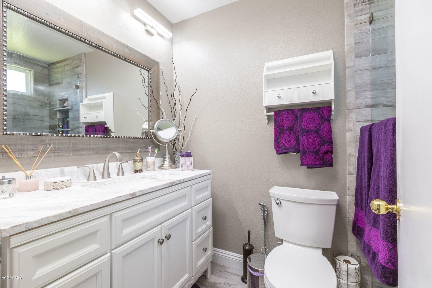 1411 Kelp Street Oxnard, CA 93035 - Photo 14 of 24 a bathroom with a toilet sink and mirror