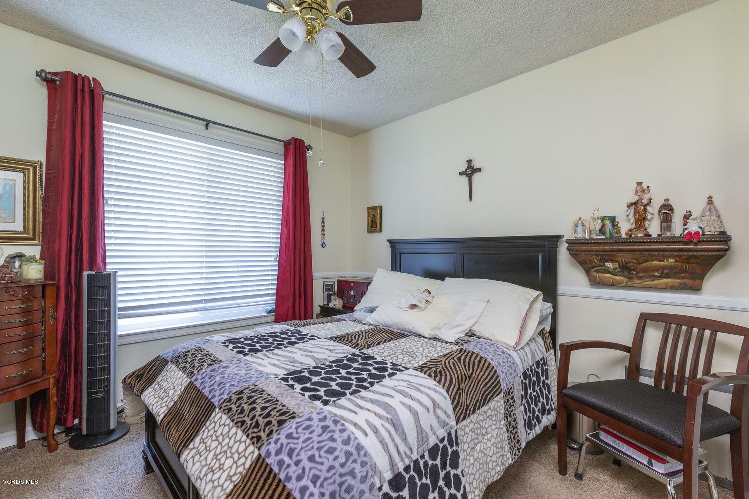 1411 Kelp Street Oxnard, CA 93035 - Photo 17 of 24 a bedroom with a bed and a chandelier