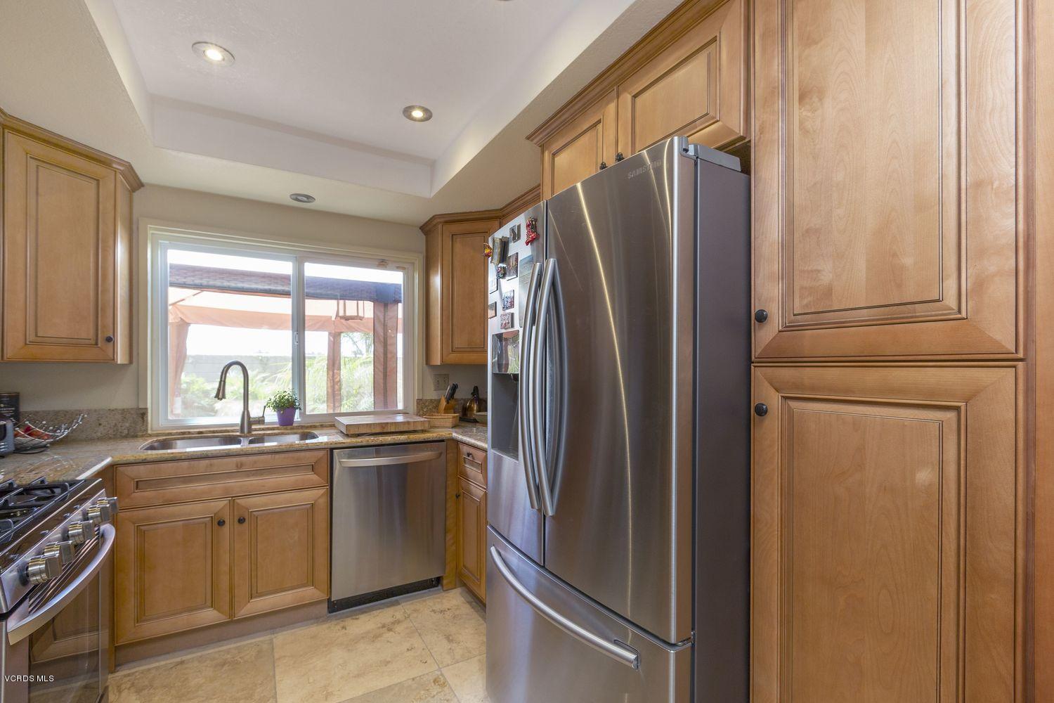 1411 Kelp Street Oxnard, CA 93035 - Photo 7 of 24 a kitchen with stainless steel appliances granite countertop a refrigerator and a sink