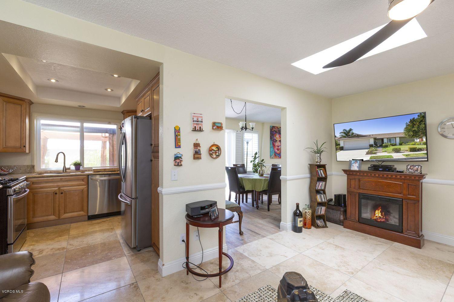 1411 Kelp Street Oxnard, CA 93035 - Photo 8 of 24 a living room with furniture a fireplace and kitchen view