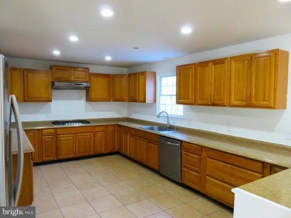 a view of a kitchen with a sink and cabinets