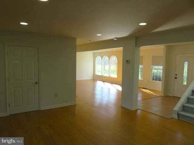 a view of a room has a window and wooden floor