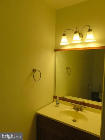 a bathroom with a sink a mirror and shower