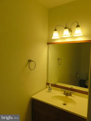 a bathroom with a sink a mirror and shower