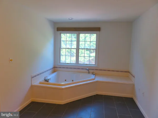 a view of a fireplace and window in a room
