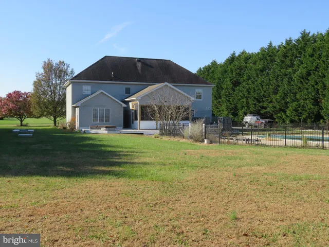 a view of a house with swimming pool and sitting area