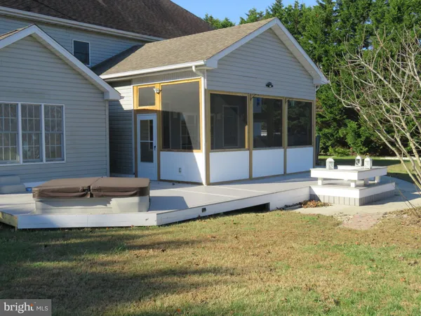 a view of a lake with couches and wooden fence