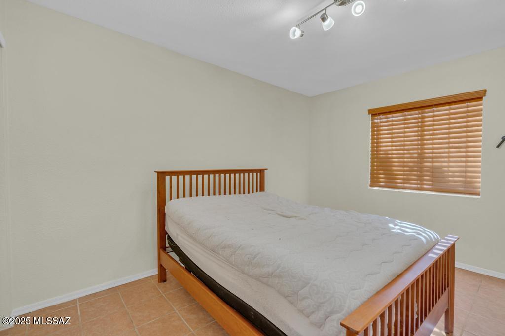 211 West Roger Road, Unit 35 Tucson, AZ 85705 - Photo 12 of 24 a bedroom with a bed and a window