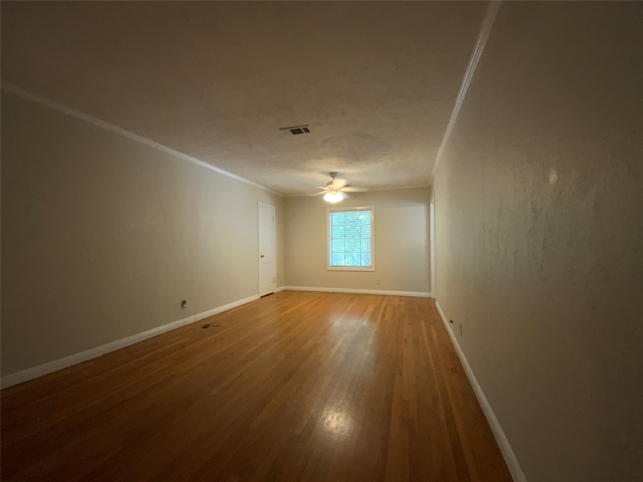 2327 Branard Street, Unit 5 Houston, TX 77098 - Photo 3 of 17 an empty room with wooden floor and windows
