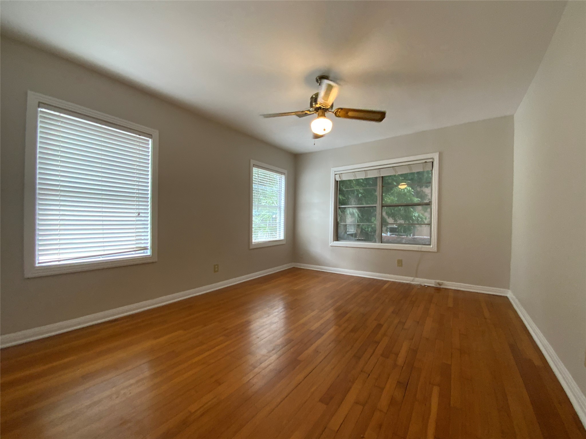 2327 Branard Street, Unit 5 Houston, TX 77098 - Photo 4 of 17 a view of an empty room with a window and wooden floor