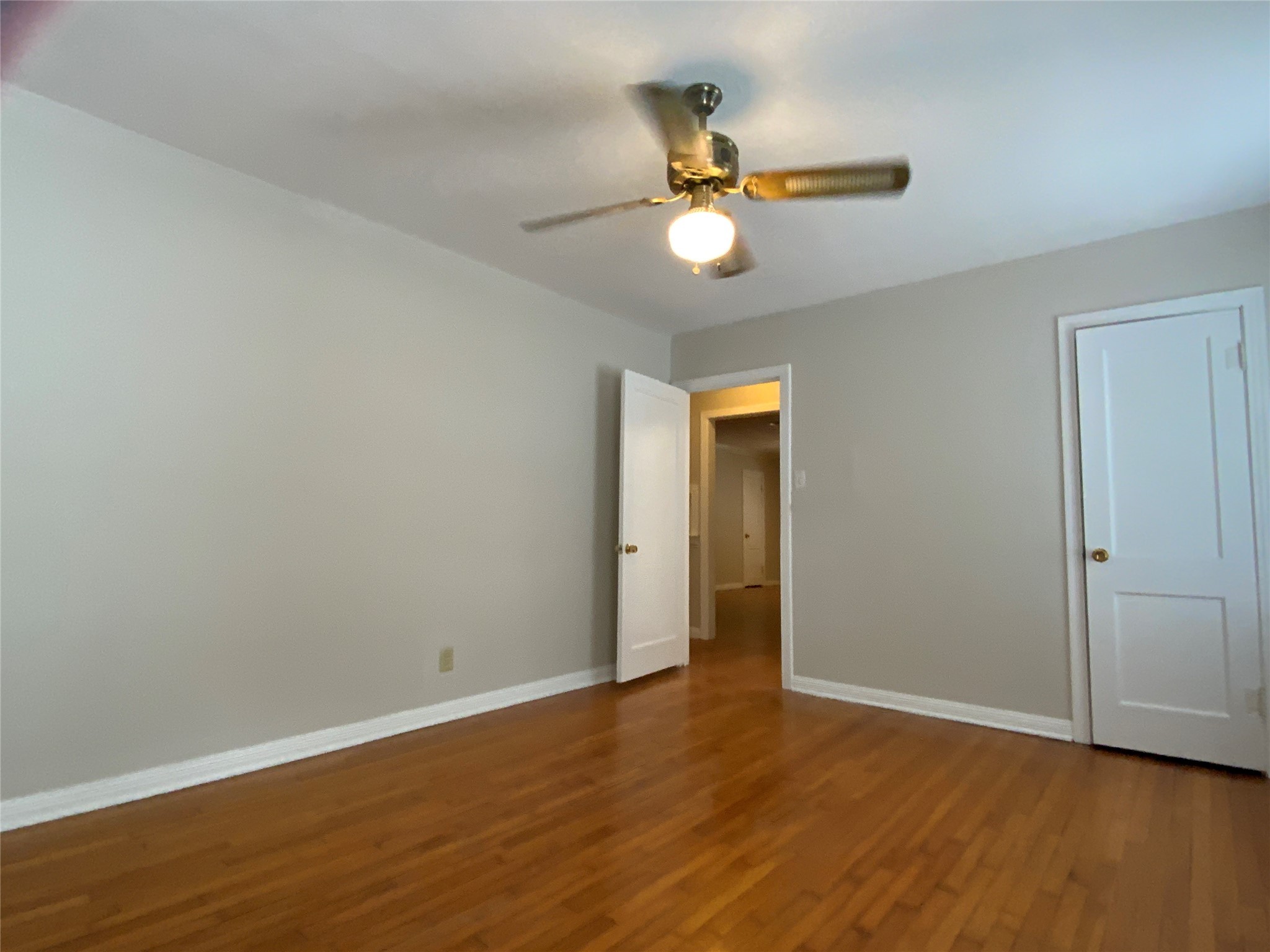 2327 Branard Street, Unit 5 Houston, TX 77098 - Photo 5 of 17 a view of an empty room with wooden floor and a window