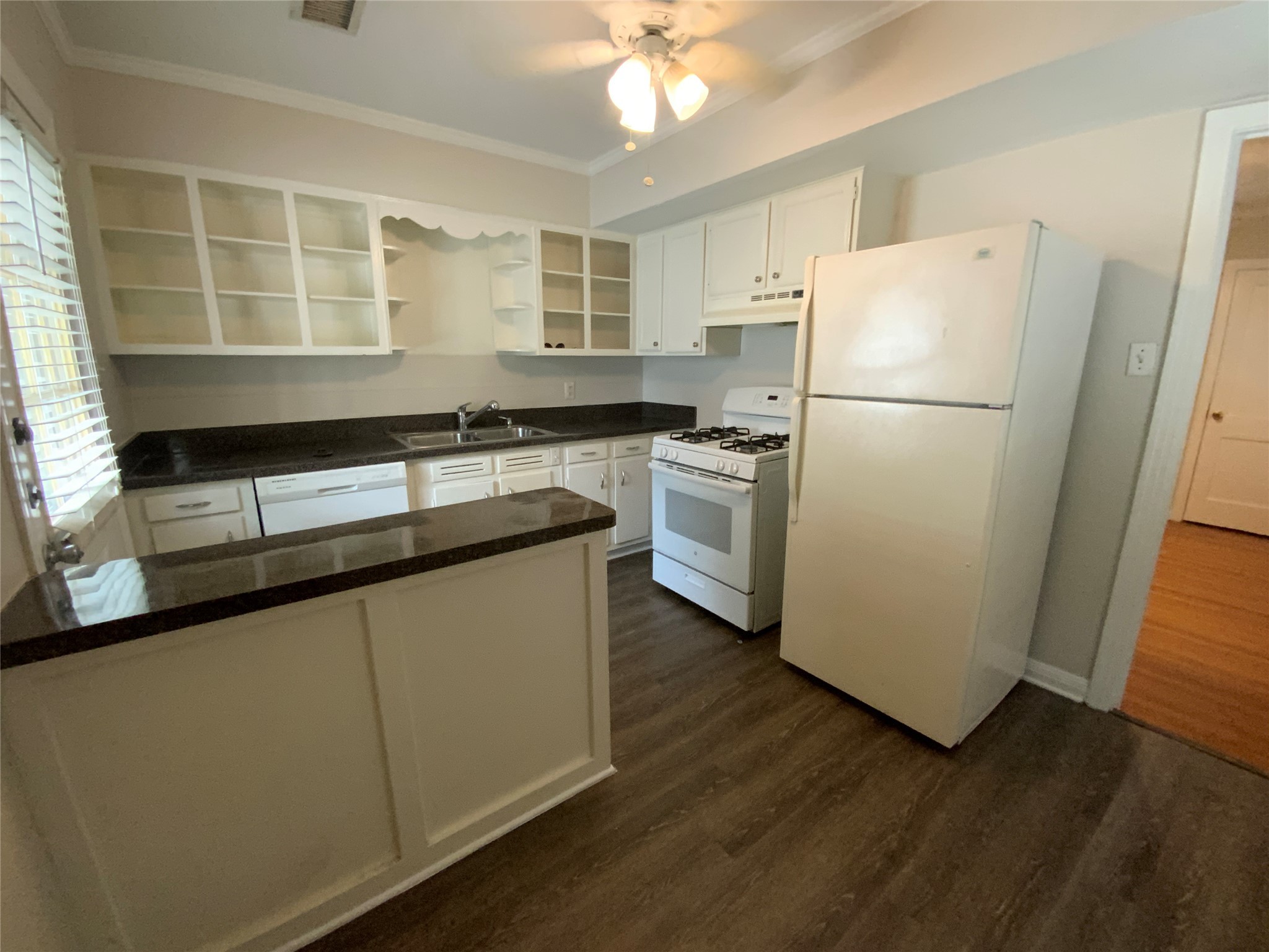 2327 Branard Street, Unit 5 Houston, TX 77098 - Photo 8 of 17 a kitchen with granite countertop a refrigerator a sink a stove a microwave and island