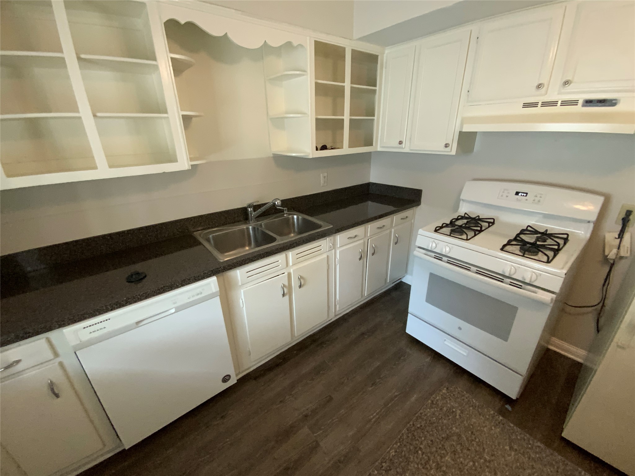 2327 Branard Street, Unit 5 Houston, TX 77098 - Photo 10 of 17 a kitchen with granite countertop white cabinets and black appliances
