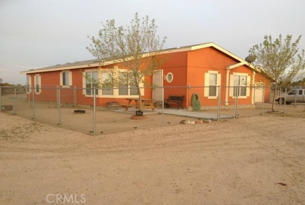 6781 Rancho Road Phelan, CA 92371 - Photo 1 of 1 a view of a house with a backyard