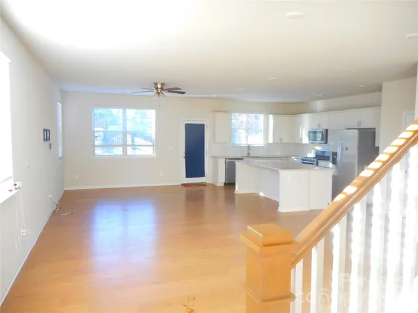 a view of a kitchen and an entryway with wooden floor