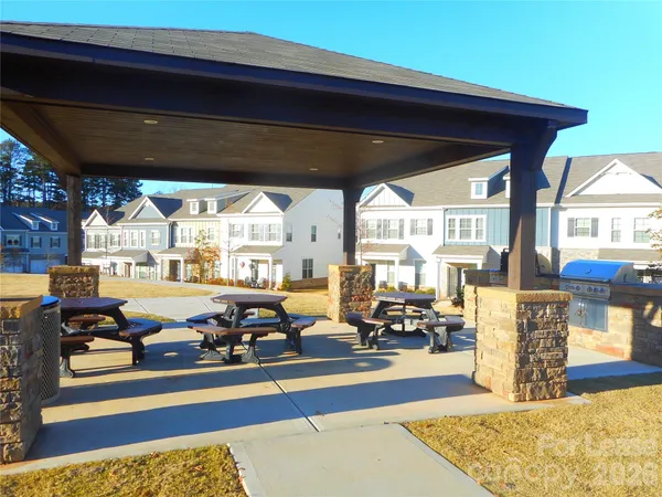 a living room with lots of furniture and a large window
