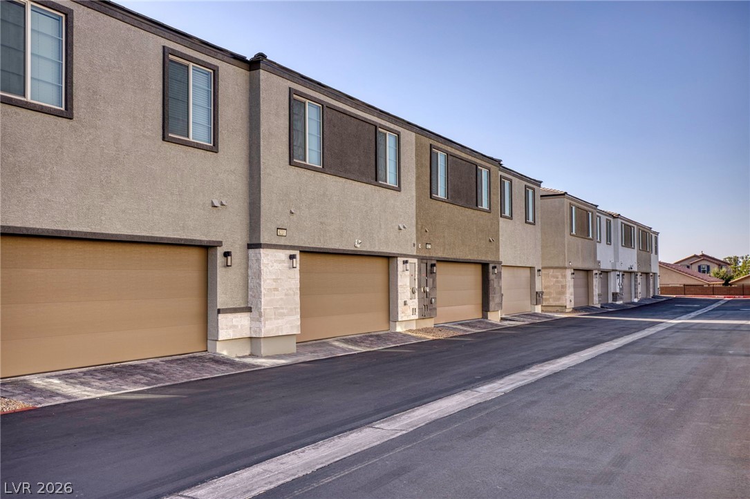 This modern row of townhomes features sleek design and individual garages for ultimate convenience.