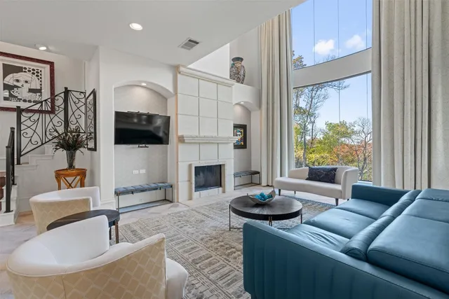 a living room with fireplace furniture and a flat screen tv