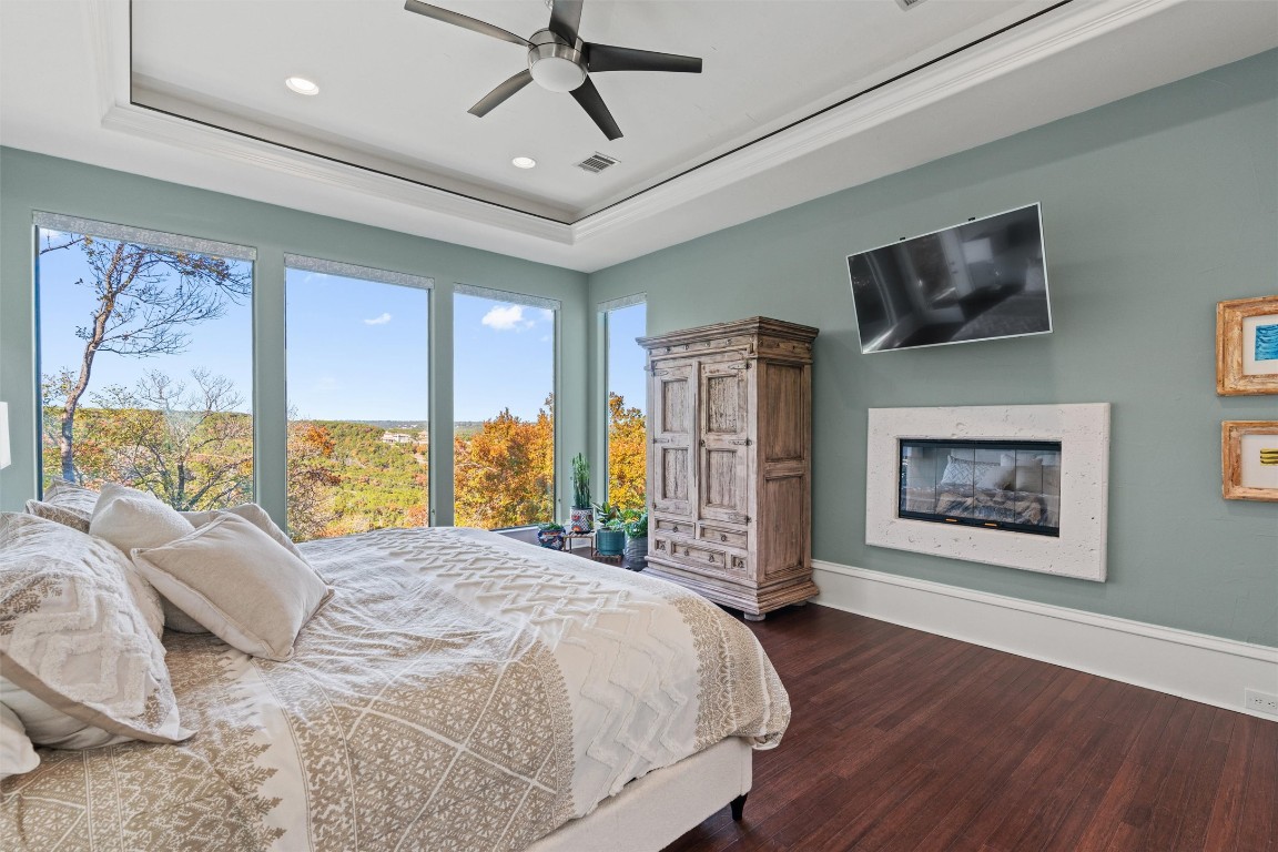 5706 Long Court Austin, TX 78730 - Photo 21 of 40 a bedroom with a large bed and a large window