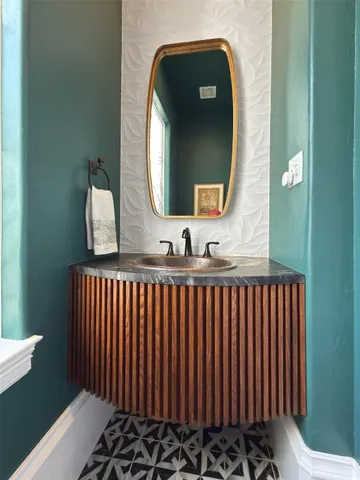 a bathroom with a sink and a mirror