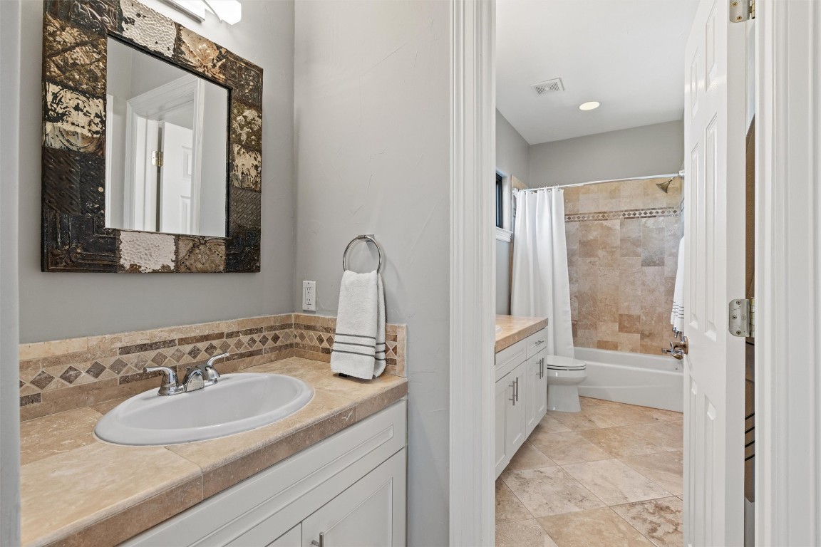 5706 Long Court Austin, TX 78730 - Photo 40 of 40 a bathroom with a sink a toilet and a mirror